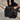 Woman carrying a handcrafted black smooth leather Estate Bag by Laurent Nay Maroquinerie