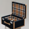 Open Heritage decorative trunk with a black exterior, natural leather trim and tartan lining, handcrafted in France.